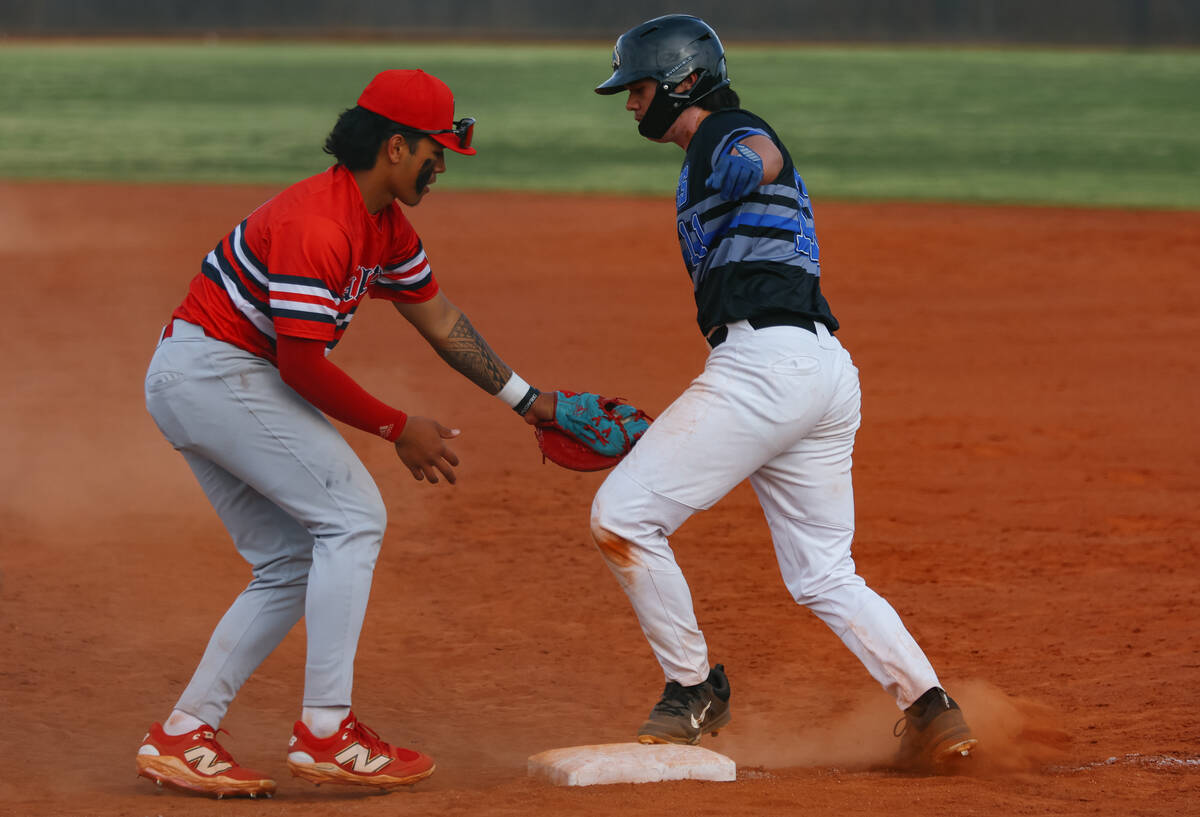 Liberty first baseman Jaydrien Klein-Baker (9) tags Basic Academy’s Gabe Giron (11) just ...