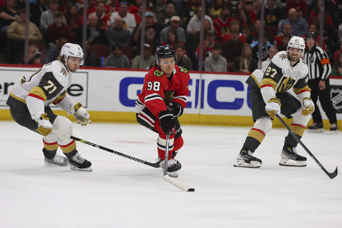 Chicago Blackhawks center Connor Bedard (98) controls the puck against Vegas Golden Knights cen ...