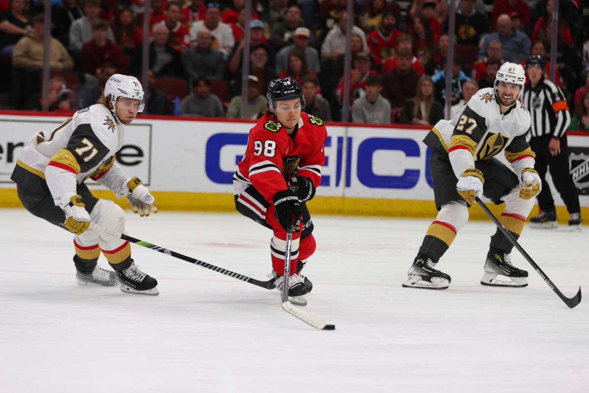 Chicago Blackhawks center Connor Bedard (98) controls the puck against Vegas Golden Knights cen ...