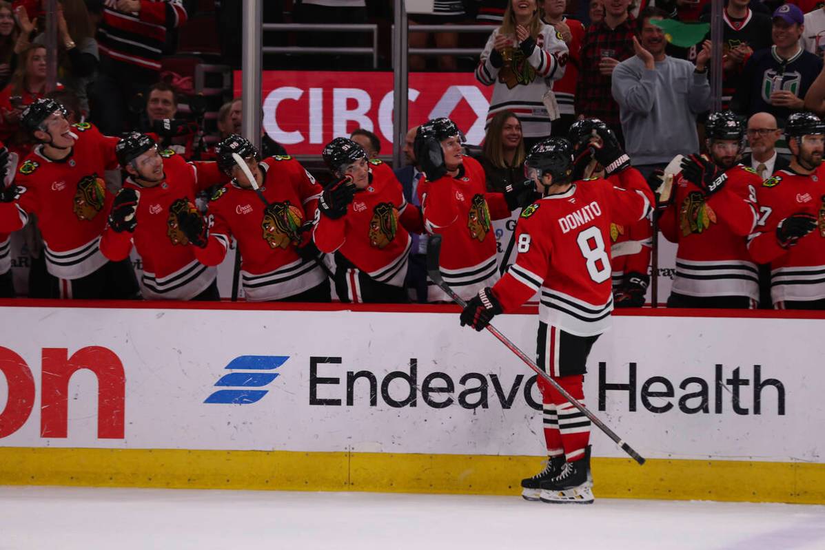 Chicago Blackhawks center Ryan Donato (8) celebrates with teammates in the second period after ...