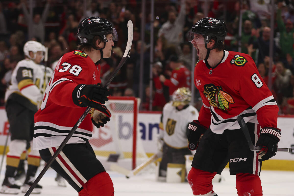 Chicago Blackhawks center Ryan Donato (8) celebrates with defenseman Ethan Del Mastro (38) in t ...