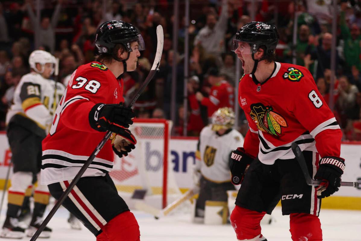 Chicago Blackhawks center Ryan Donato (8) celebrates with defenseman Ethan Del Mastro (38) in t ...