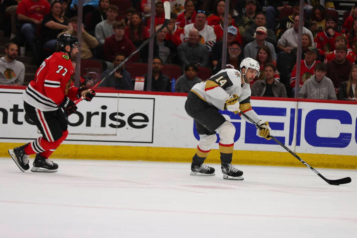 Vegas Golden Knights defenseman Nicolas Hague (14) controls the puck against Chicago Blackhawks ...