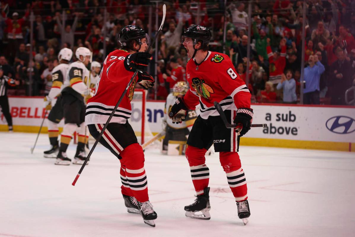 Chicago Blackhawks center Ryan Donato (8) celebrates with Chicago Blackhawks defenseman Ethan D ...