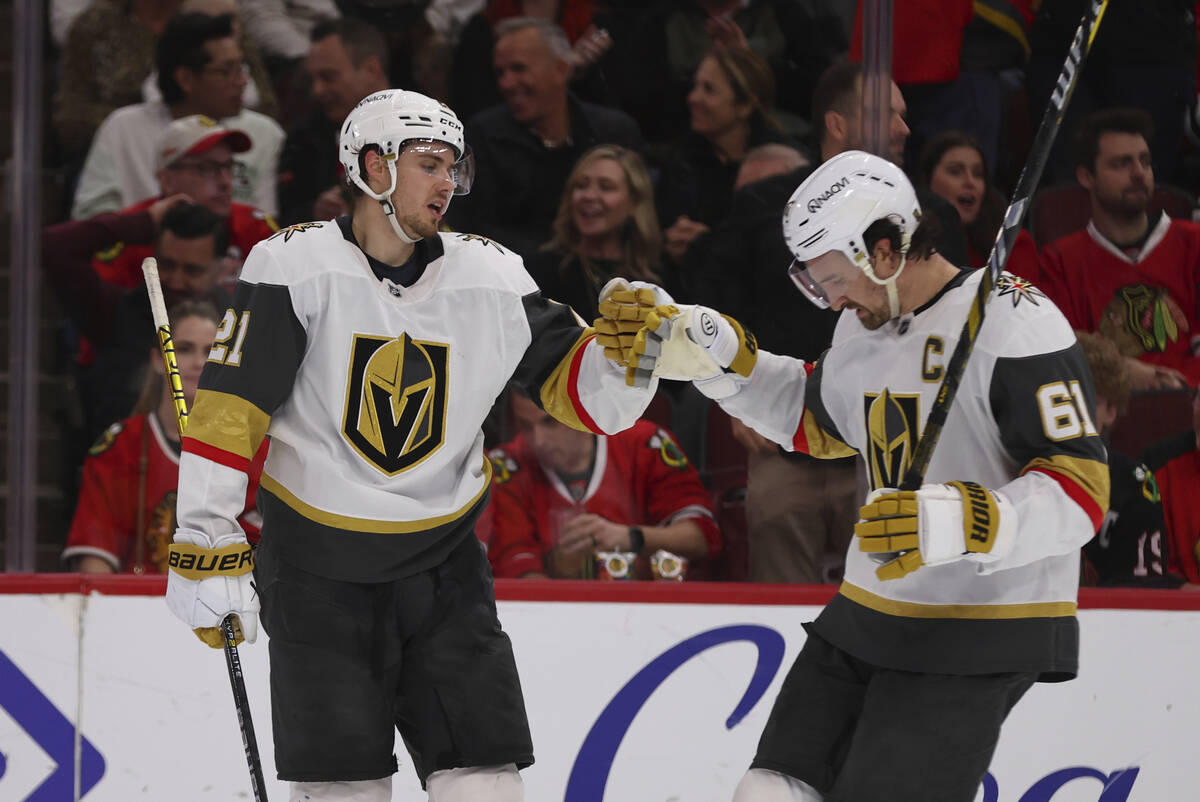 Vegas Golden Knights center Brett Howden (21) celebrates with right wing Mark Stone (61) after ...