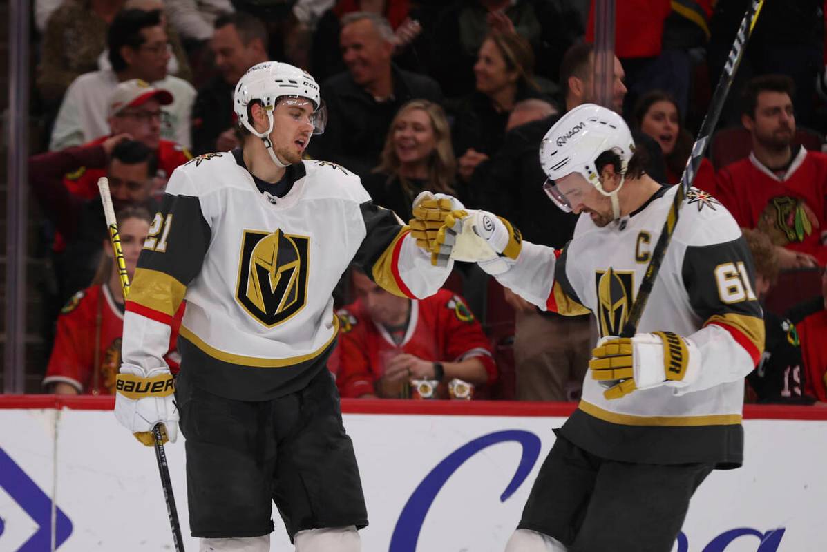 Vegas Golden Knights center Brett Howden (21) celebrates with right wing Mark Stone (61) after ...