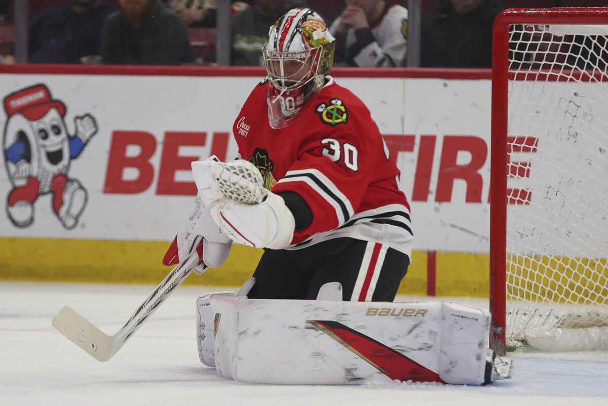 Chicago Blackhawks goaltender Spencer Knight (30) makes a save during the first period of an NH ...