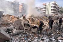 Firemen inspect the area after an Israeli army strike in the suburb of Dahiye, Beirut, Friday M ...