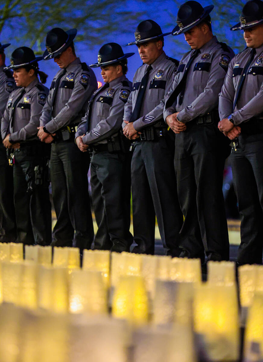 Troopers stand quietly behind during a vigil hosted by the Nevada Highway Patrol to honor traff ...