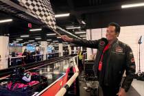 Wayne Newton waves the checkered flag to end the first karting race at F1 Drive inside Grand Pr ...