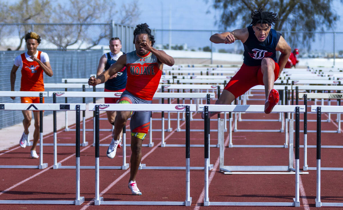 Liberty's Sean Craig keeps a short lead on Mojave's Antwan Hawkins battle in the varsity boys 1 ...