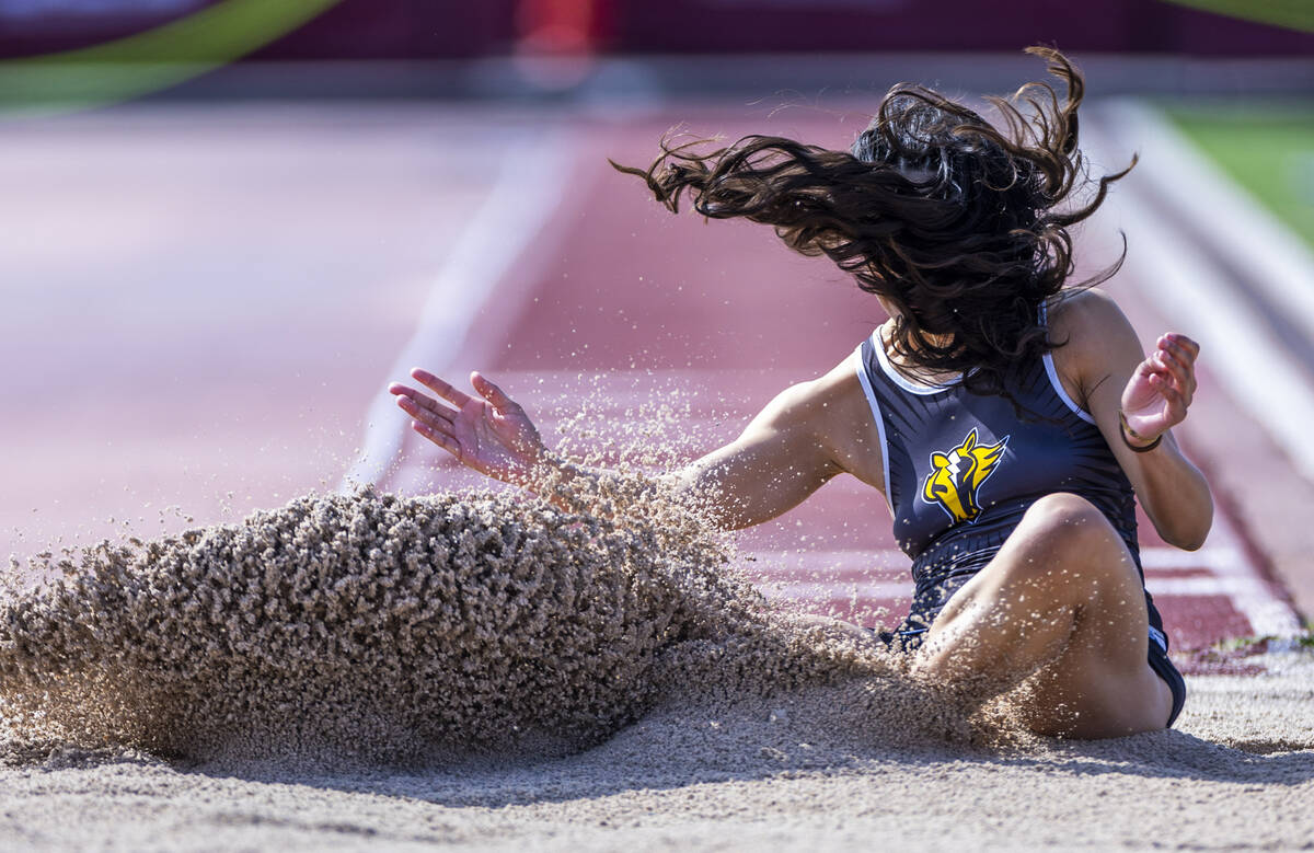 Clark's Aylin Chavez digs into the sand on landing in the varsity girls long jump during the 20 ...
