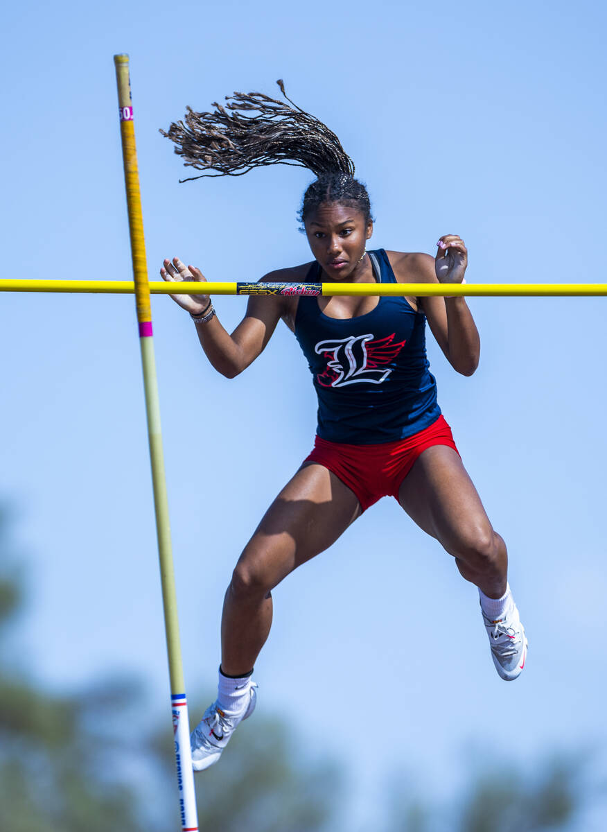 Liberty's Isabella Clark eyes the pole after clearing 11-2 in the varsity girls pole vault duri ...