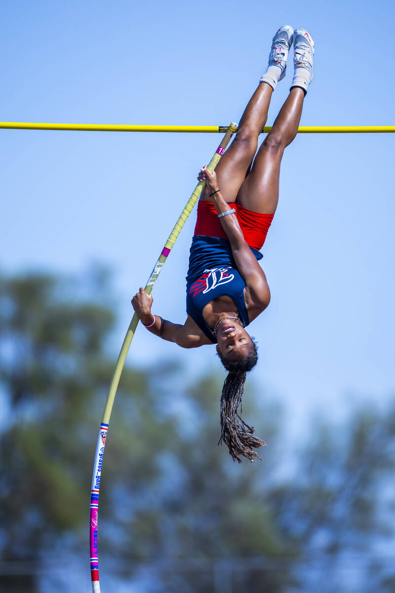 Liberty's Isabella Clark explodes upward on her way to clear 11-8 for the win in the varsity gi ...