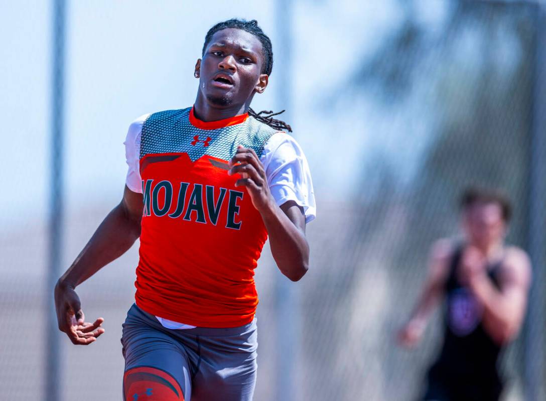 Mojave's Aries Denson turns the corner in the varsity boys 400 meters race during the 2025 Las ...