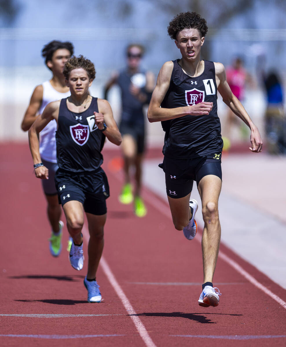 Faith Lutheran's Brady Anderson leads teammate Logan Scott to the finish line of the boys 800 m ...