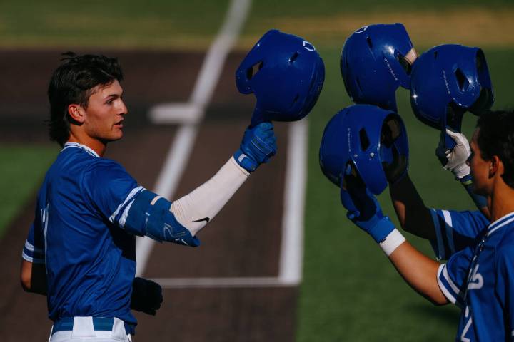 Bishop Gorman’s Nolan Eberwein (17) bumps helmets with teammates after hitting a home ru ...