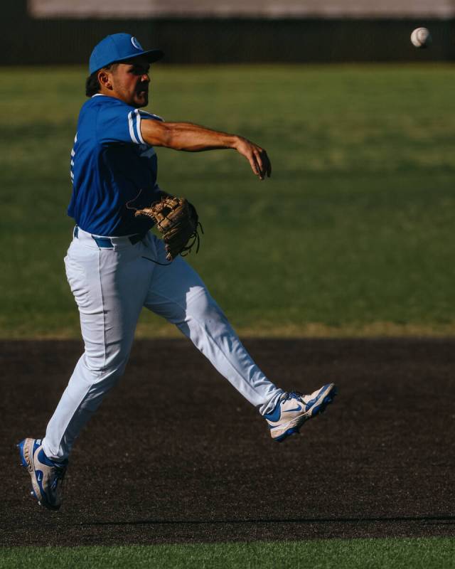 Bishop Gorman third baseman Jonas Yatson (27) throws the ball to first base to attempt a put ou ...