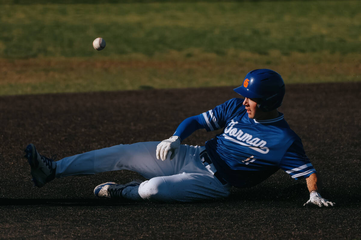 Bishop Gorman’s Jojo Rouvas (11) races against the ball as he slides into third base dur ...