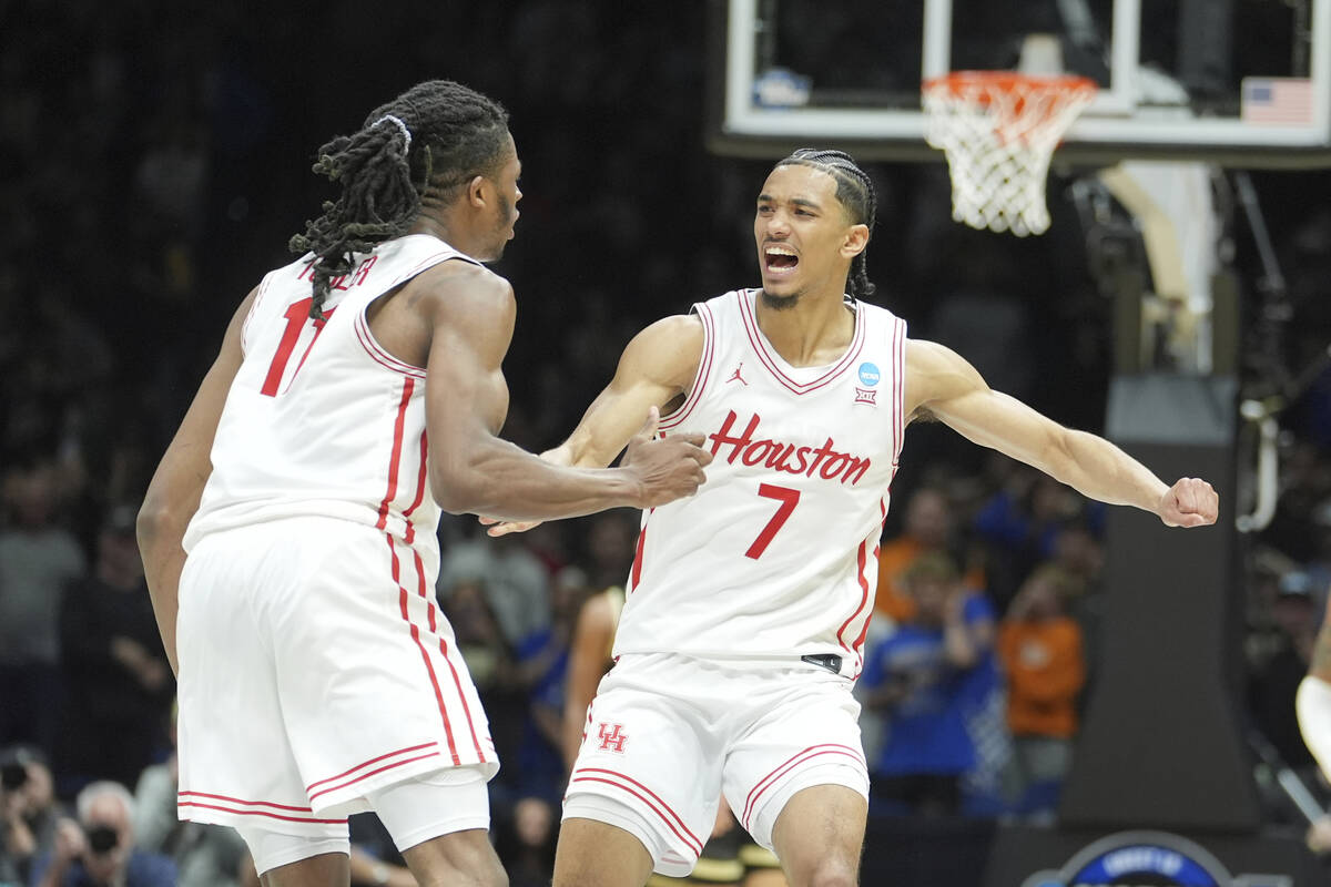 Houston's Milos Uzan (7) is congratulated by teammate Joseph Tugler after making a basket again ...