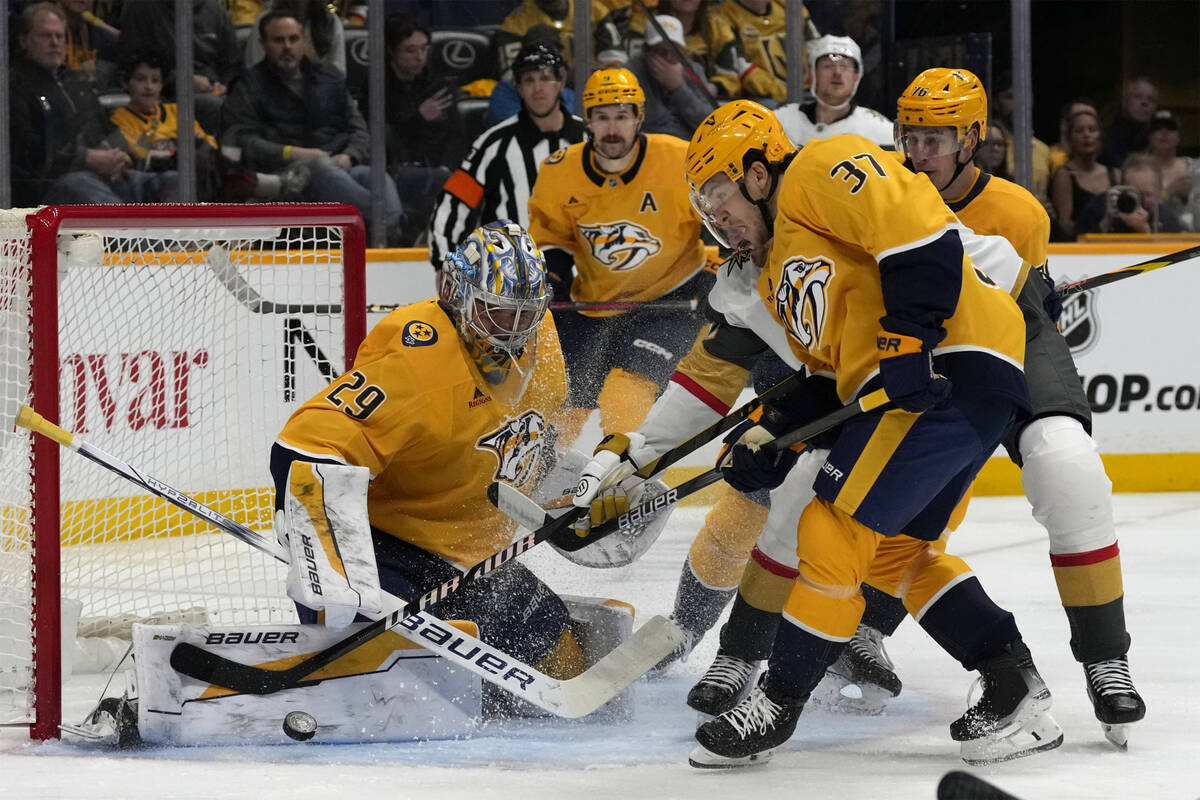 Nashville Predators goaltender Justus Annunen (29) and defenseman Nick Blankenburg (37) clear t ...