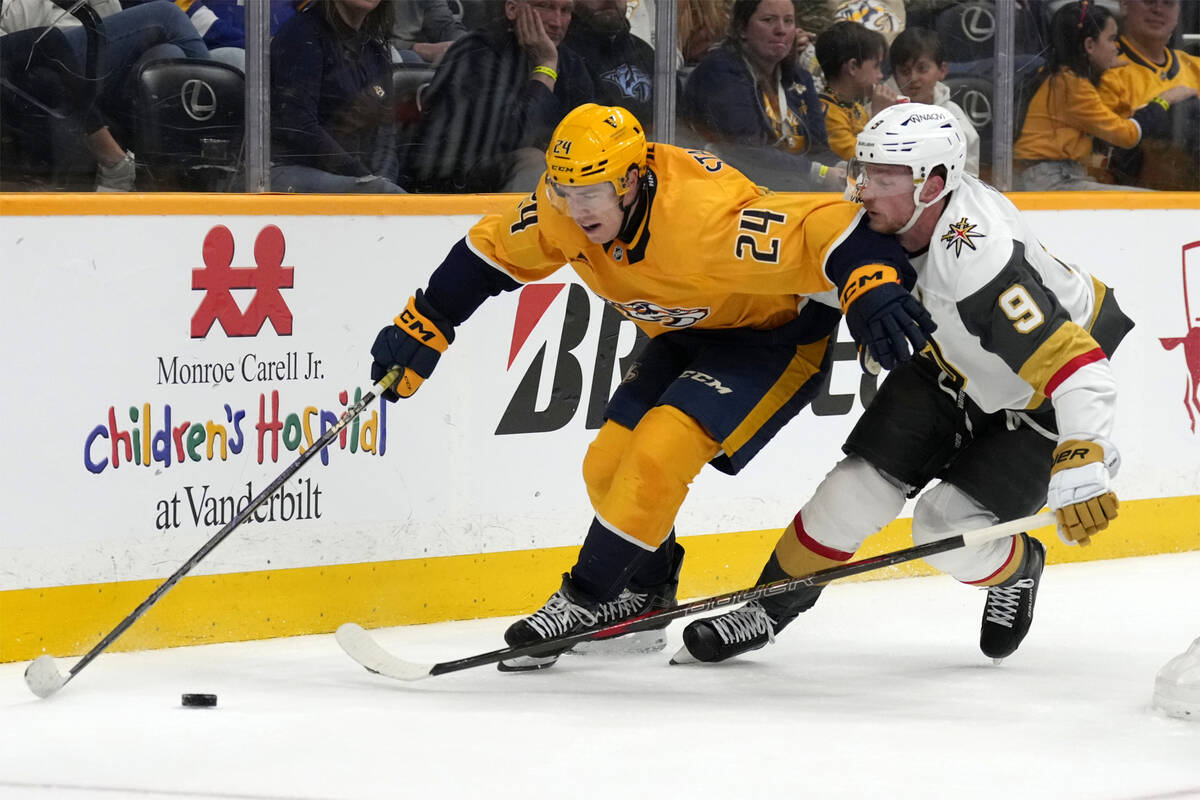 Nashville Predators defenseman Spencer Stastney (24) vies for the puck with Vegas Golden Knight ...