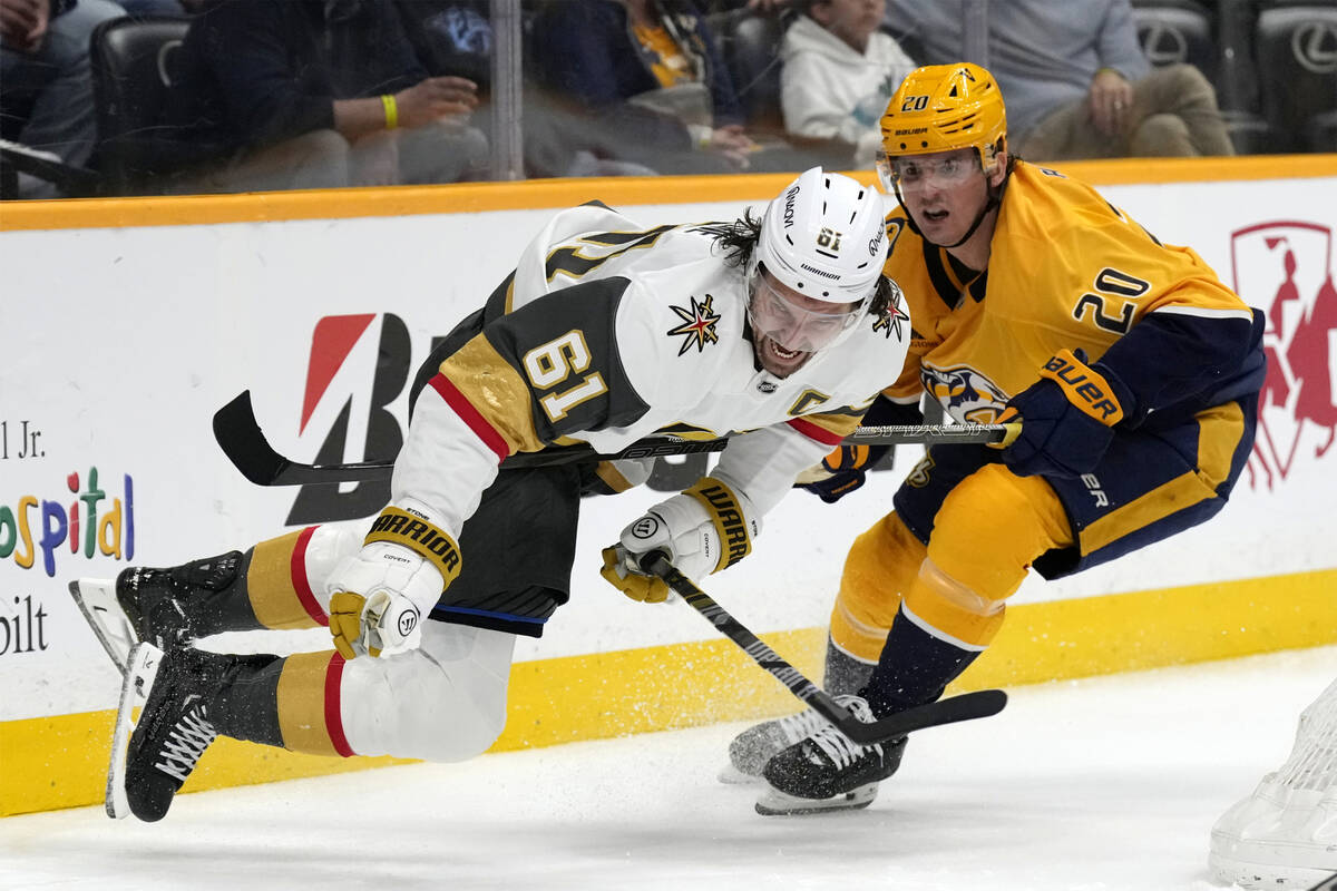Vegas Golden Knights right wing Mark Stone (61) falls over the stick of Nashville Predators def ...