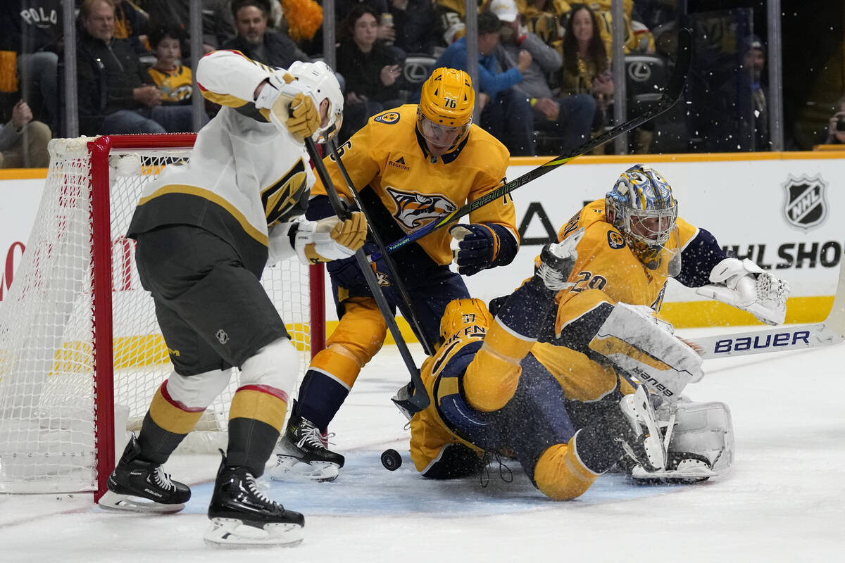 Vegas Golden Knights right wing Reilly Smith, left, scores against the Nashville Predators duri ...