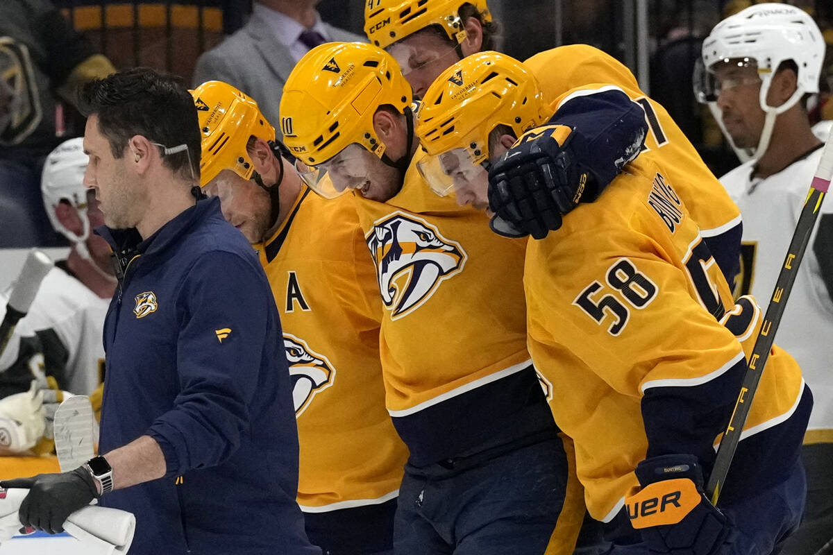 Nashville Predators center Colton Sissons (10) is helped off the ice after being injured during ...