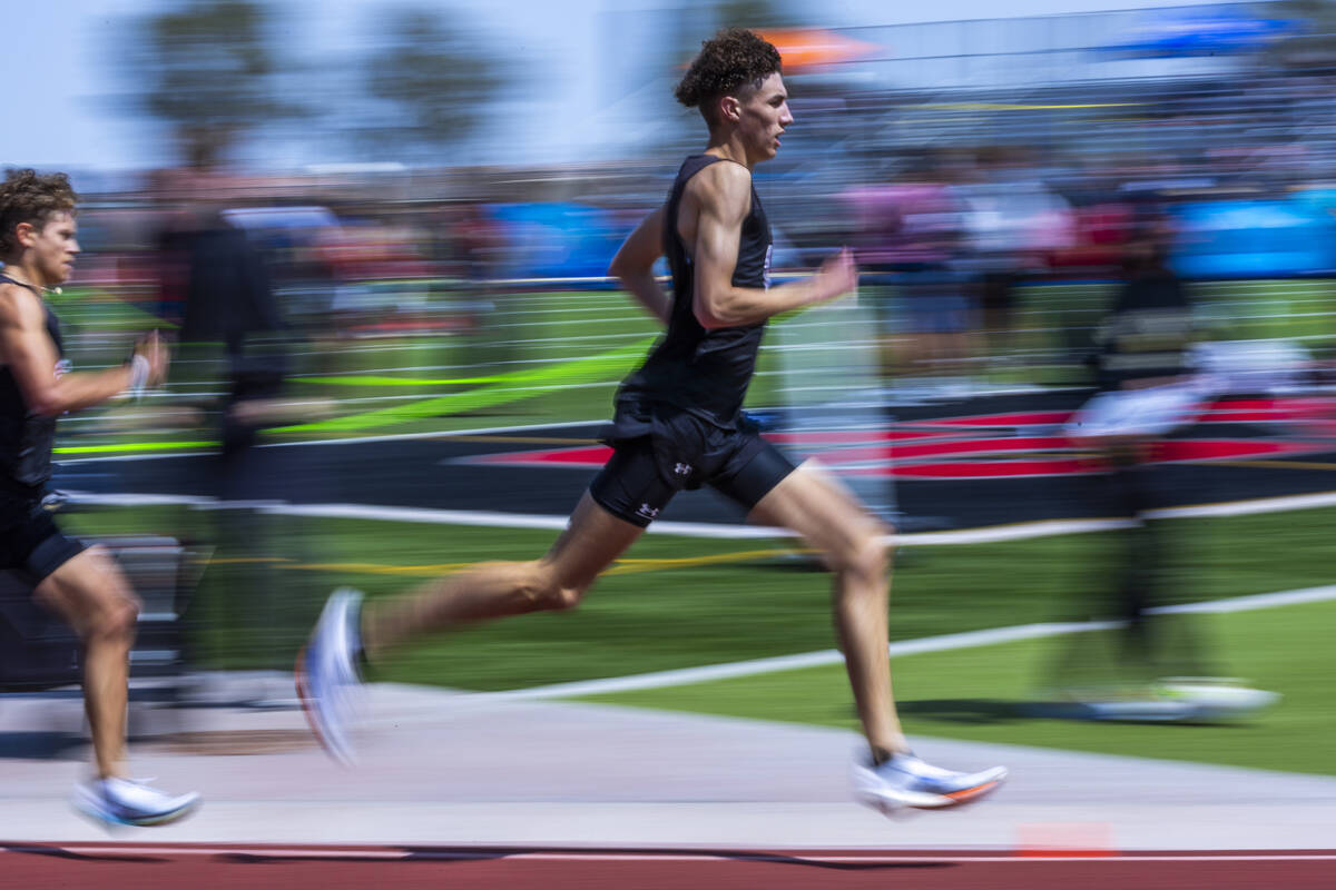 Faith Lutheran's Brady Anderson leads teammate Logan Scott into the second lap of the boy's 800 ...