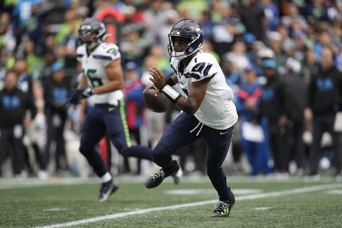 Seattle Seahawks quarterback Geno Smith (7) rushes with the ball during an NFL football game ag ...