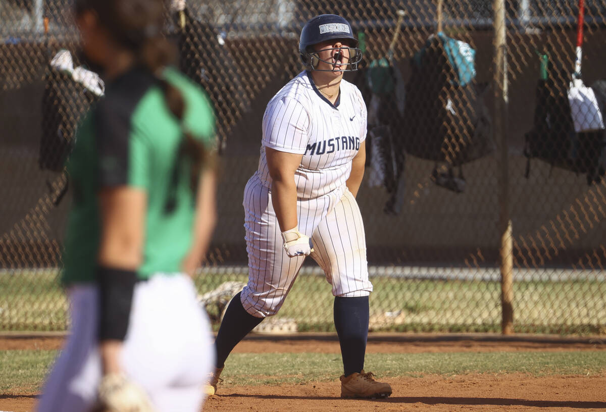 Shadow Ridge's Jacobi Gledhill celebrates after reaching first base against Palo Verde during a ...