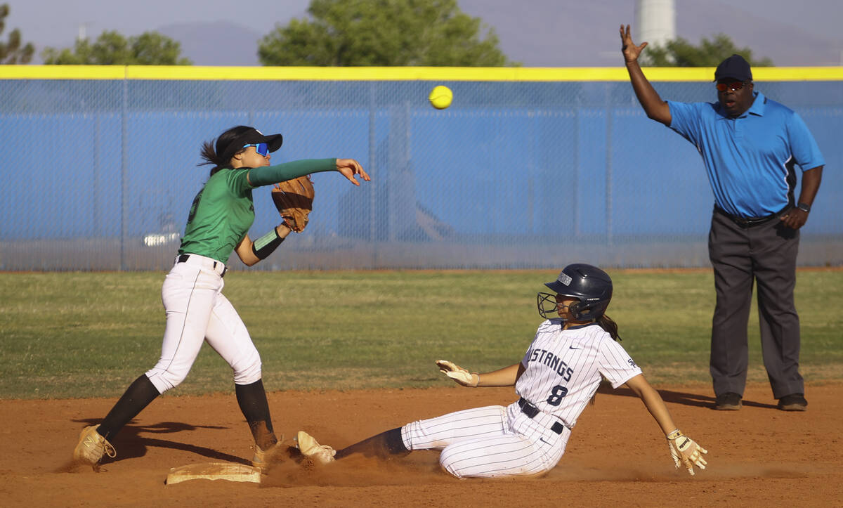 Palo Verde's Ava Cruz (5) throws to first base after tagging out Shadow Ridge's Madelynn Quidat ...