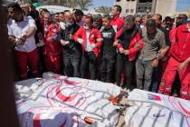 Mourners gather around the bodies of 8 Red Crescent emergency responders, recovered in Rafah a ...