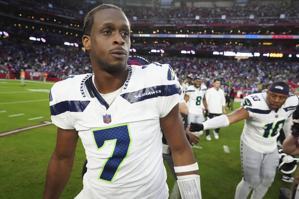 Seattle Seahawks quarterback Geno Smith walks off the field after an NFL football game against ...