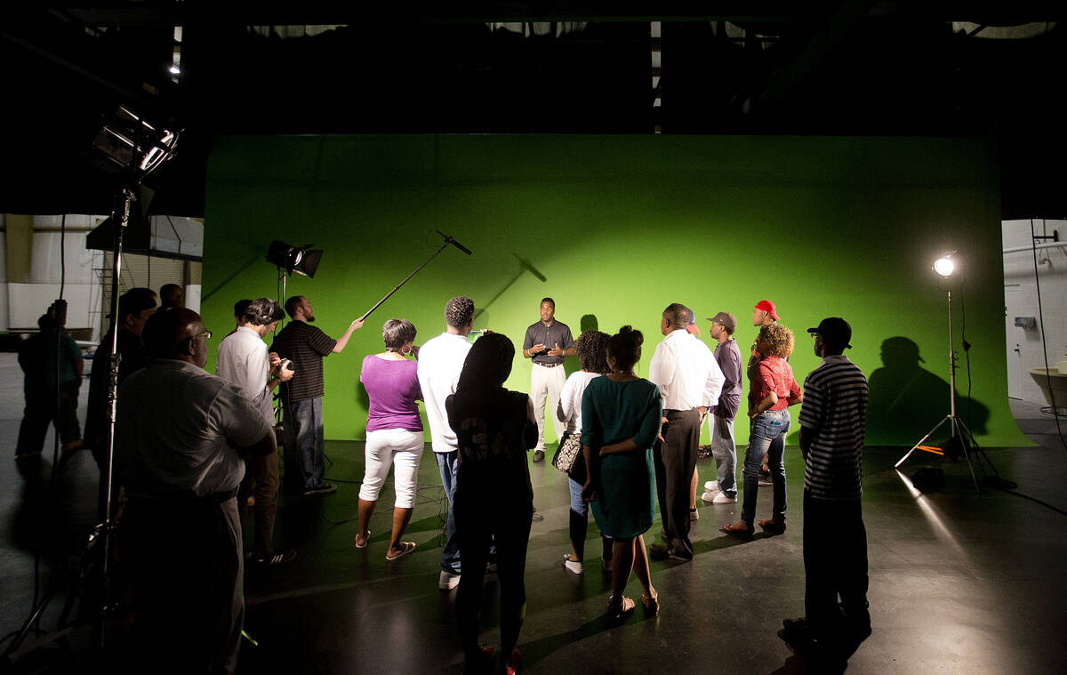 In this Tuesday July 7, 2015 photo, students gather for a lesson on audio equipment in a studio ...