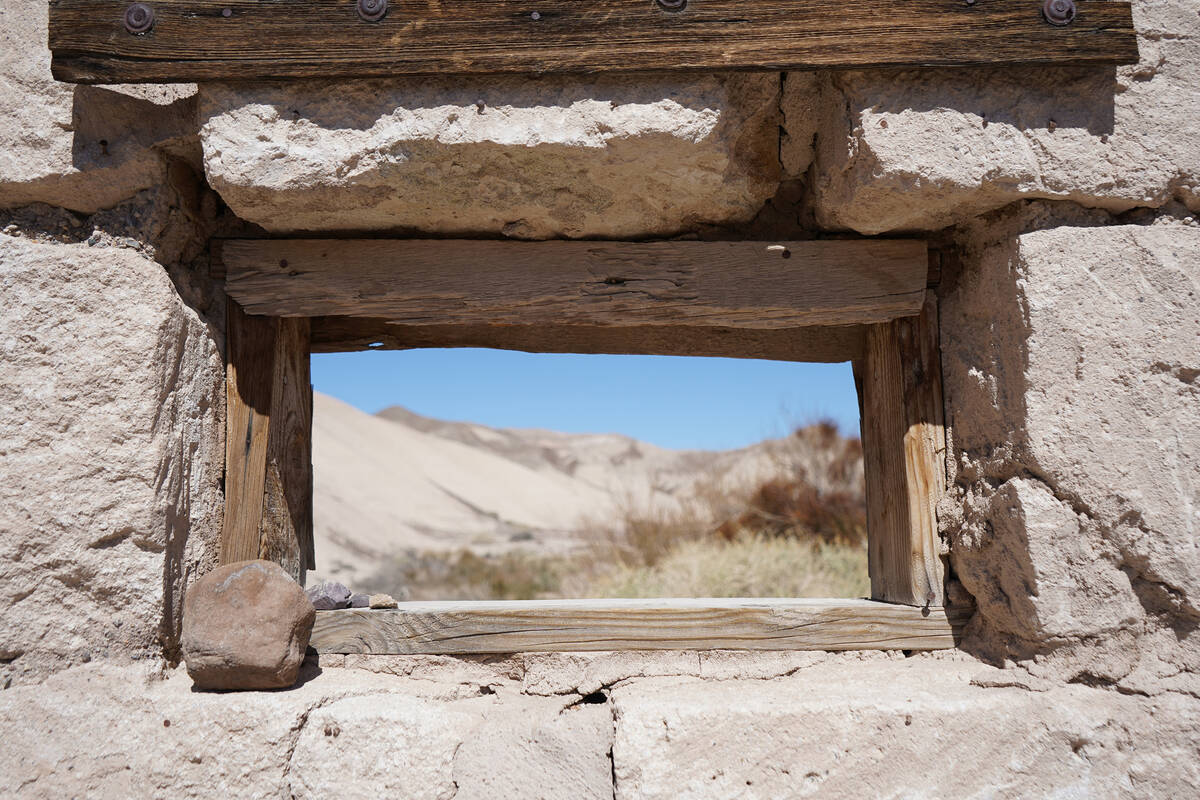 A window frames part of the surrounding landscape from the historic building that hikers encoun ...