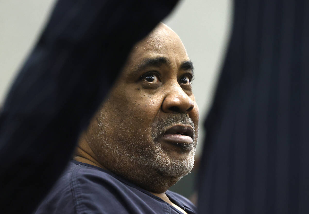 Duane Davis, facing murder charges in the killing of rapper Tupac Shakur in 1996, listens to hi ...