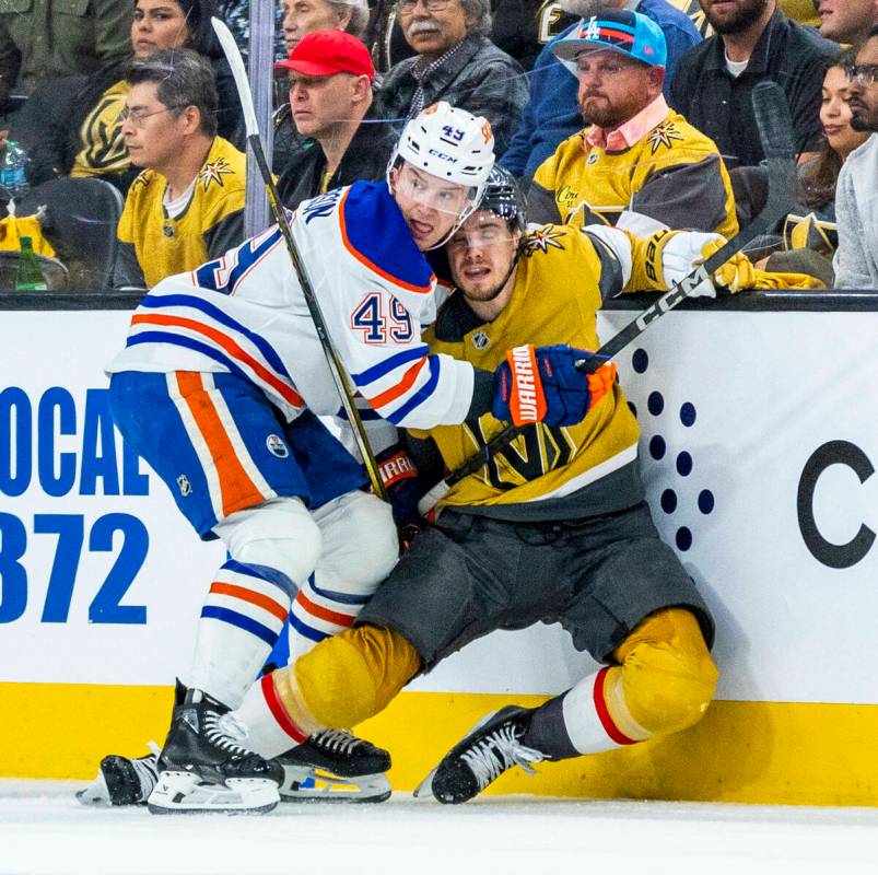 Edmonton Oilers defenseman Ty Emberson (49) and Golden Knights center Brett Howden (21) looks t ...