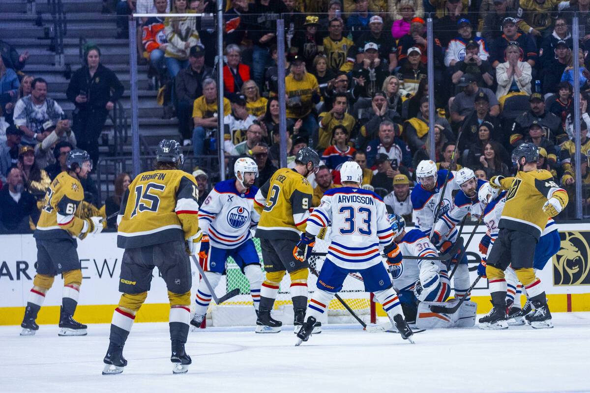 Golden Knights and Edmonton Oilers players mix it up after a shot on goal during the second per ...