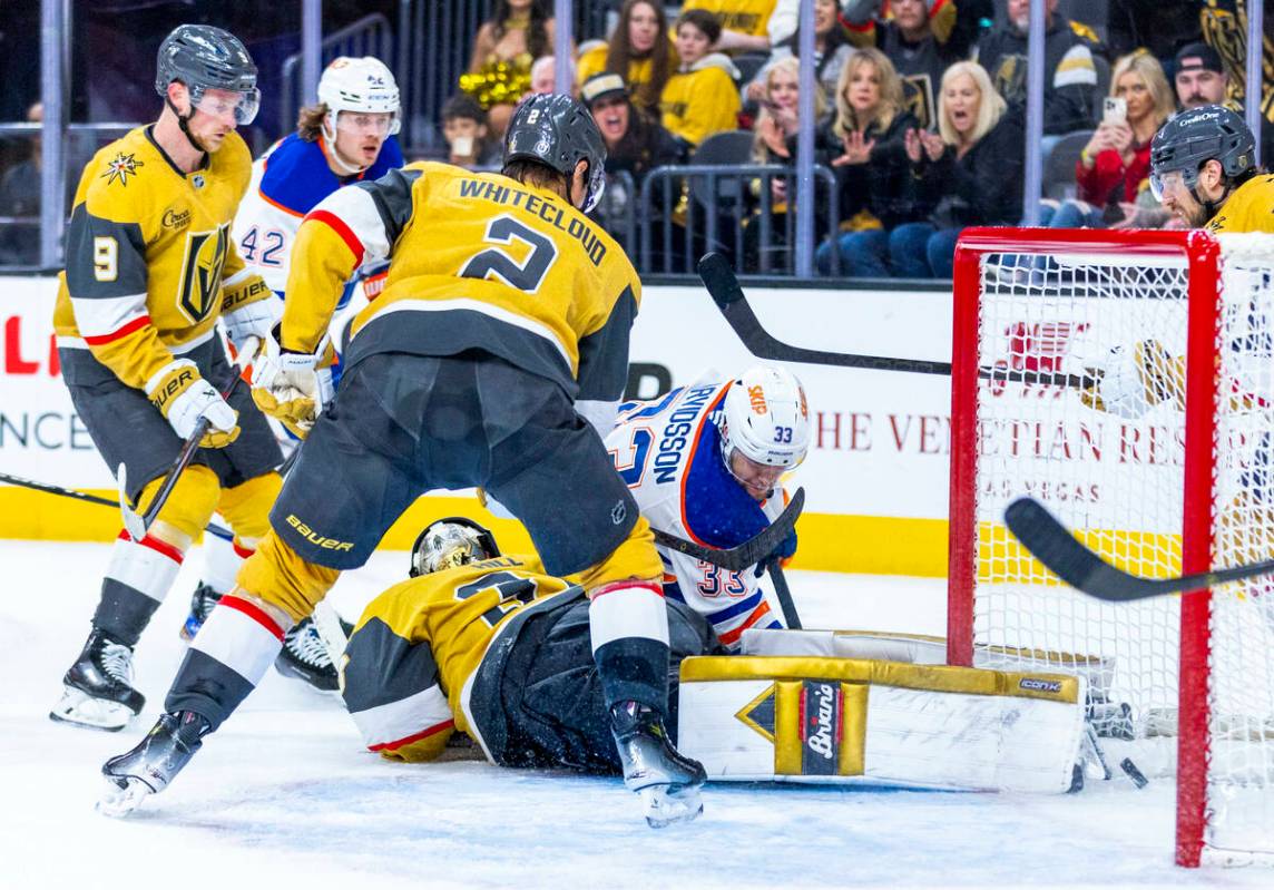 Golden Knights goaltender Adin Hill (33) dives on the ice but is unable to stop a shot from Edm ...