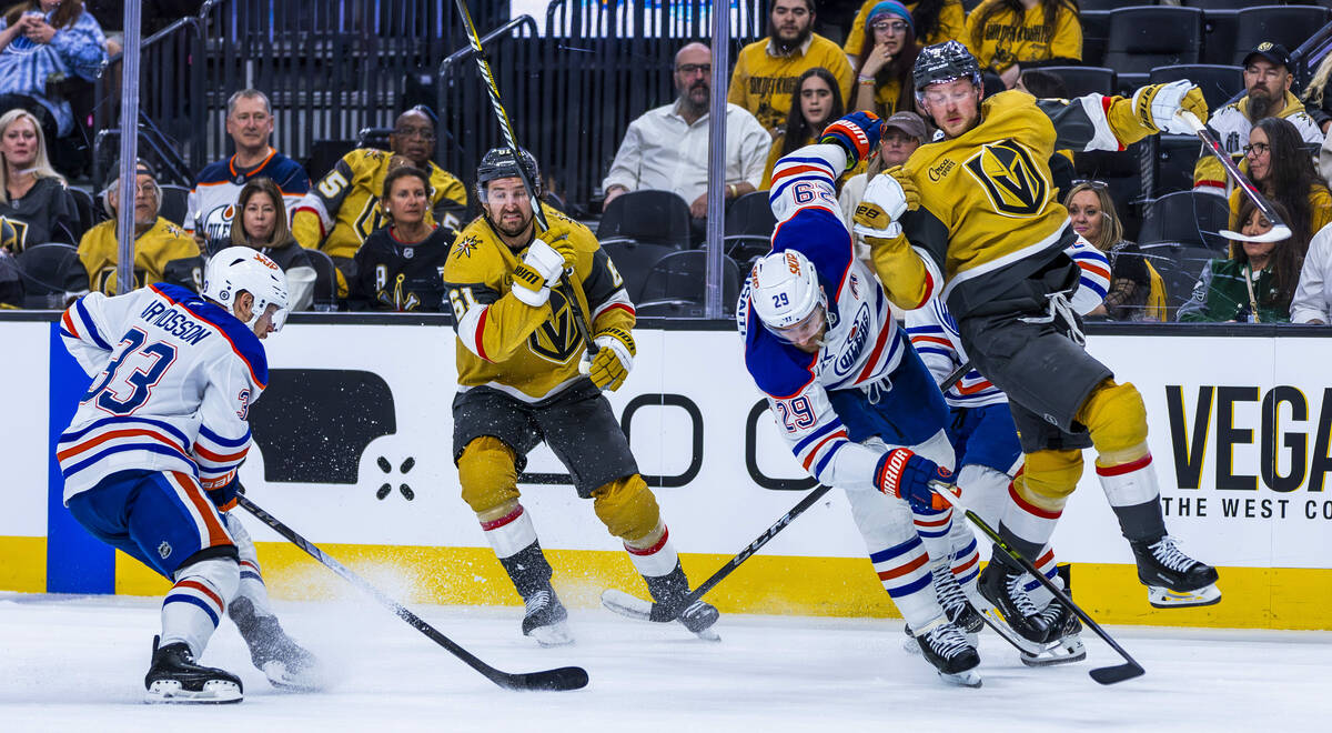 Golden Knights center Jack Eichel (9) is undercut by Edmonton Oilers center Leon Draisaitl (29) ...