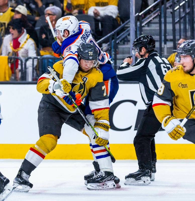 Golden Knights center William Karlsson (71) is tied up after a face off with Edmonton Oilers ce ...