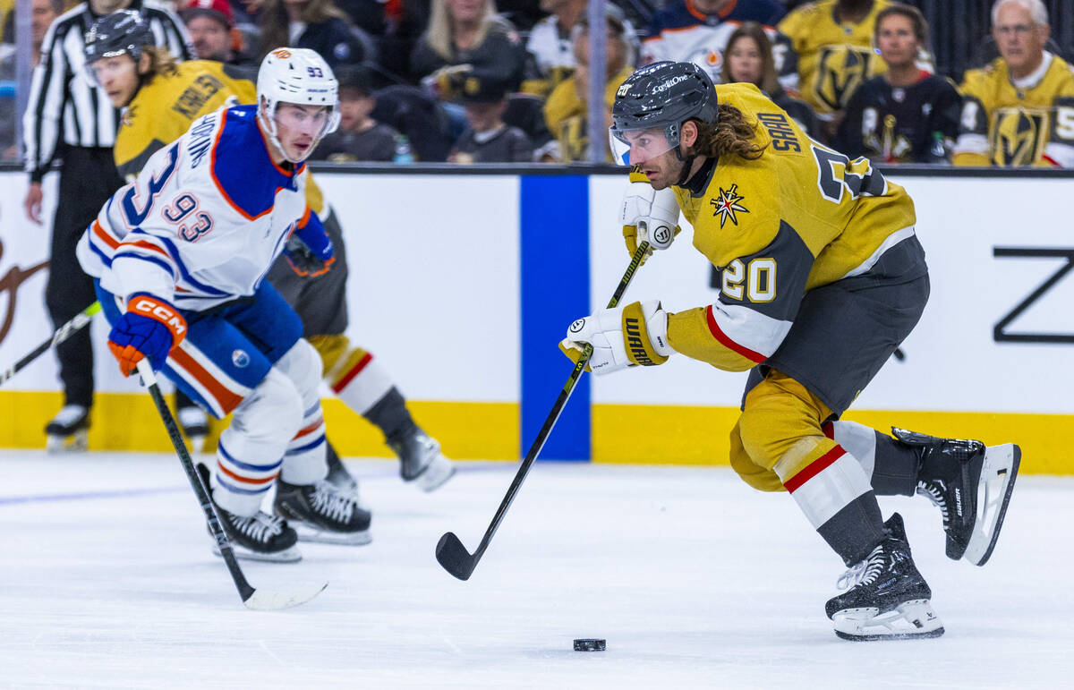 Golden Knights left wing Brandon Saad (20) advances the puck as Edmonton Oilers center Ryan Nug ...