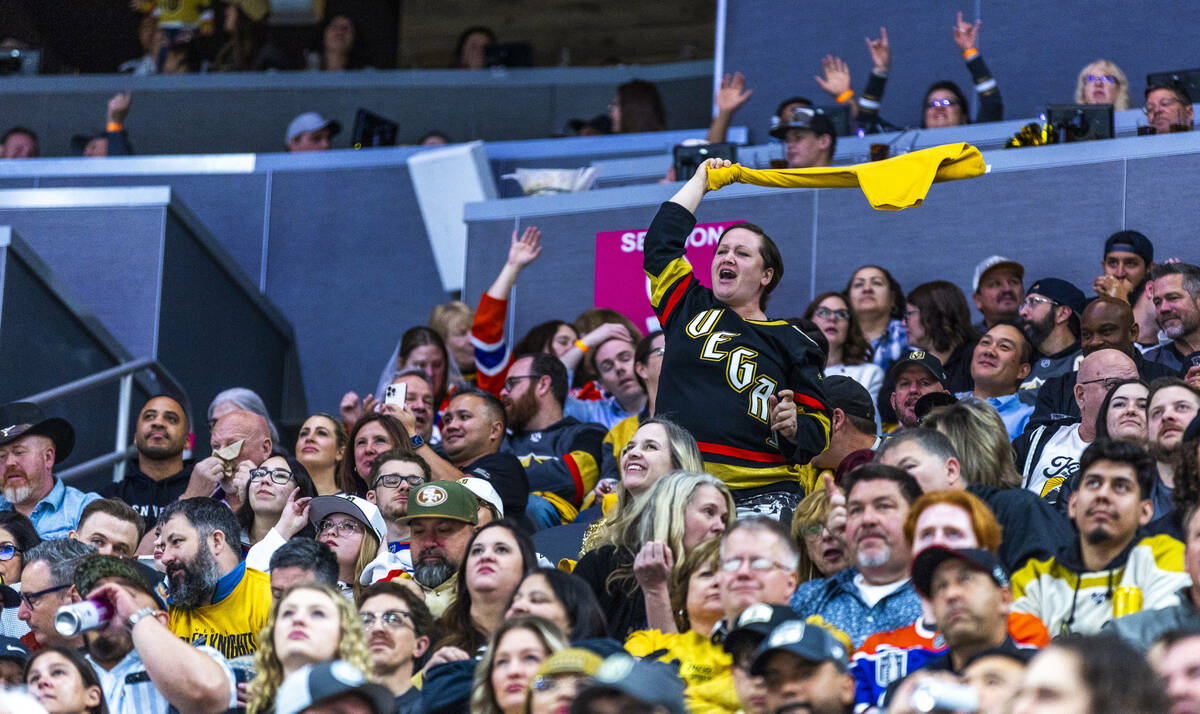 A Golden Knights fan cheers the team against the Edmonton Oilers during the second period in th ...