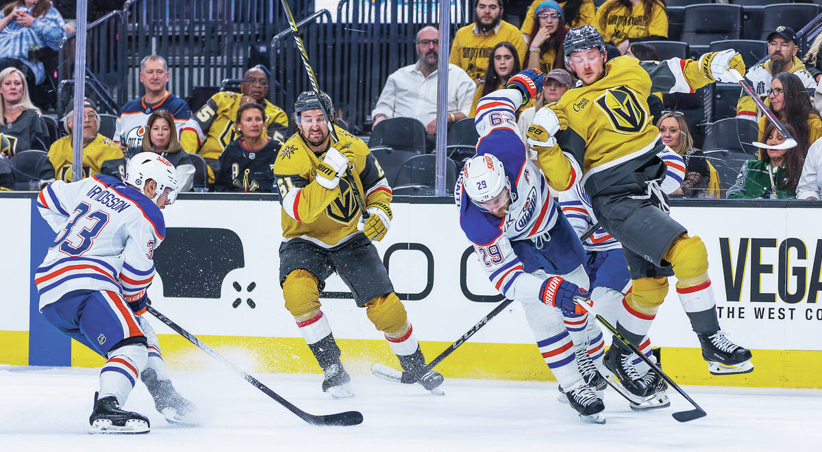 Golden Knights center Jack Eichel (9) is undercut by Edmonton Oilers center Leon Draisaitl (29) ...