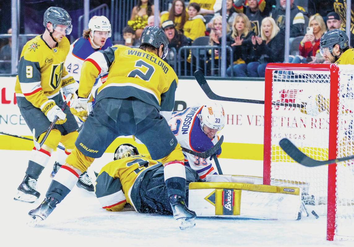 Golden Knights goaltender Adin Hill (33) dives on the ice but is unable to stop a shot from Edm ...