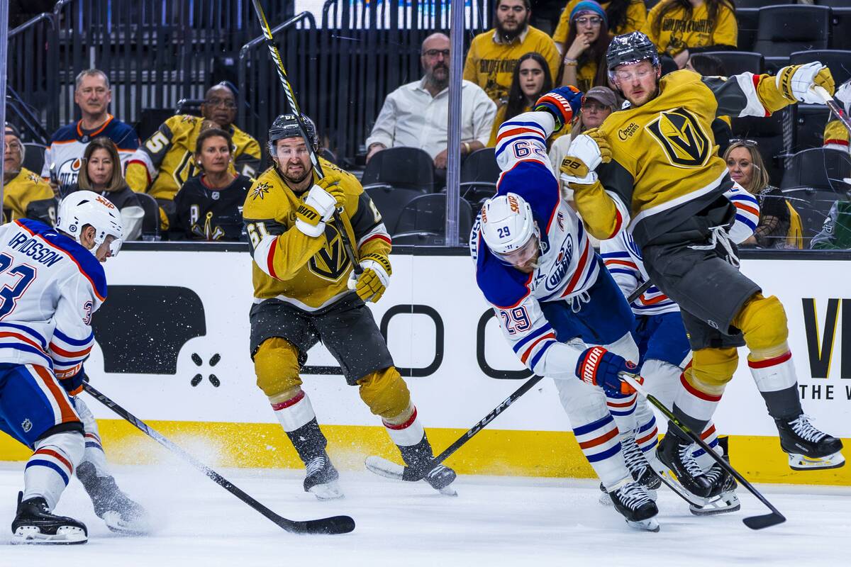 Golden Knights center Jack Eichel (9) is undercut by Edmonton Oilers center Leon Draisaitl (29) ...