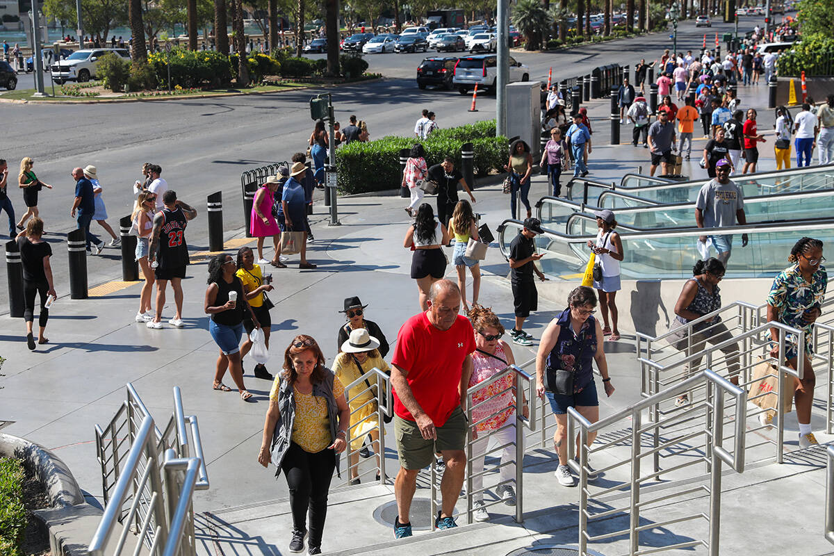 Crowds of tourists brave the heat as they walk along the Strip on Thursday, June 29, 2023, in L ...