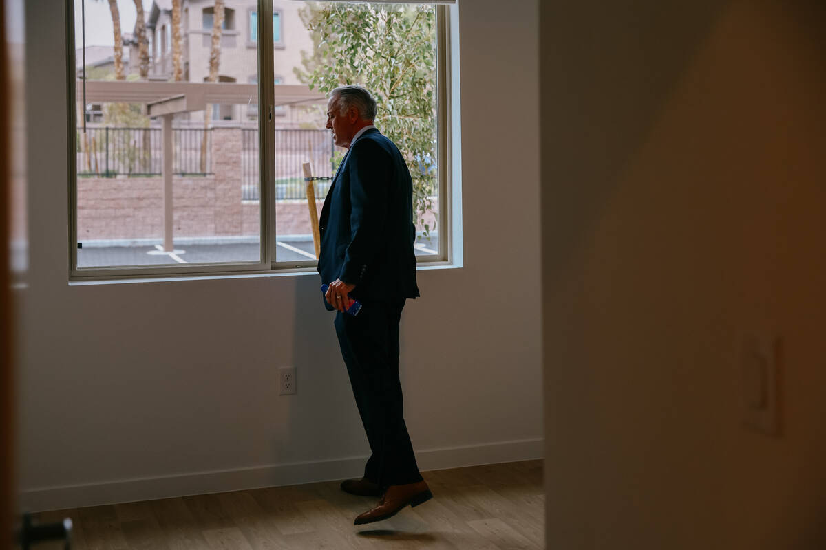 Nevada Governor Joe Lombardo looks out the window of a unit’s bedroom in a brand-new affordab ...